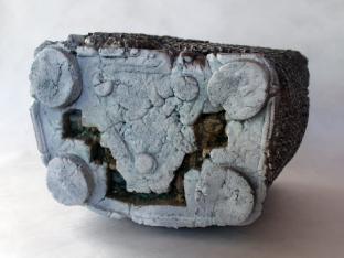 Mixed media object cast from waste materials focal point is an area of red flocking